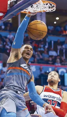 ?? AP ?? Oklahoma City Thunder guard Russell Westbrook dunks in front of Washington Wizards forward Otto Porter Jr. during the fourth quarter of their game in Oklahoma City.