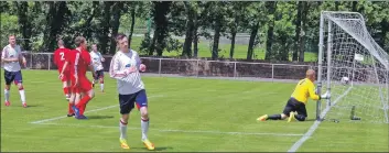  ??  ?? Craig MacEwan turns away after netting the second goal against South Lochaber.