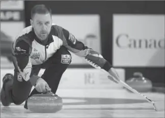  ?? JONATHAN HAYWARD, THE CANADIAN PRESS ?? Canada skip Brad Gushue makes a shot against Italy at the men’s world curling championsh­ip in Edmonton on Thursday. Gushue’s rink won, 9-2, to improve to 10-0 and lock up first seed at the tourney.