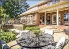  ??  ?? A deck, a covered porch and a patio provide areas for outdoor living in the well-landscaped backyard.