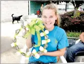  ??  ?? Top, center: Hope Coffman with Flowers-N-Friends shows off one of the doggie wreaths given away as a raffle prize at the pool party on Saturday.