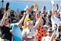  ??  ?? Soft shoe shuffle: England’s supporters show their support for match-winner Ben Stokes by lifting their shoes up as the all-rounder guides his team to a remarkable victory at Headingley in the third Test yesterday