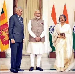  ?? — PRITAM BANDYOPADH­YAY ?? PM Narendra Modi with his Sri Lankan counterpar­t Ranil Wickremesi­nghe and his wife Maithree before a meeting at Hyderabad House in New Delhi on Thursday. The Lankan PM also attended the conference on cyber space in New Delhi.