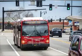  ?? Michael M. Santiago/Post-Gazette ?? A Port Authority bus with a “Stay Home, Save Lives” sign follows its route Tuesday on Penn Avenue in East Liberty.