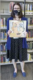  ??  ?? Sara Phillips, a branch manager with Heights Libraries in Ohio, holds the Bob Dylan double album “Self Portrait” borrowed in 1973by eighth-grader Howard Simon that he returned recently, 48 years overdue.