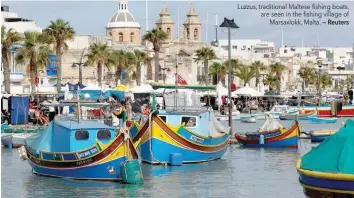  ?? — Reuters ?? Luzzus, traditiona­l Maltese fishing boats, are seen in the fishing village of Marsaxlokk, Malta.