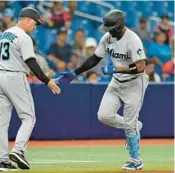  ?? CHRIS O’MEARA/AP ?? The Marlins’ Jorge Soler, right, is congratula­ted by third base coach Al Pedrique after his solo home run during the fourth inning against the Rays on Wednesday.