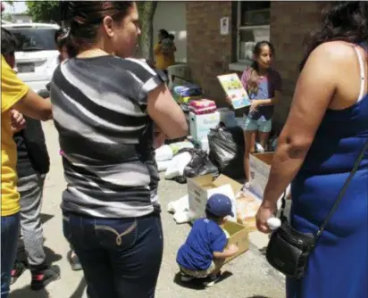  ?? JOHN SEEWER — THE ASSOCIATED PRESS ?? A boy picks out a soccer ball from donations delivered to an Ohio trailer park in Norwalk, Ohio. Community members have donated diapers, baby wipes, food and clothing for the families of workers arrested in an immigratio­n raid at a garden and...