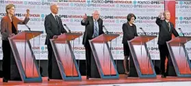  ?? CHRIS CARLSON/AP ?? Democratic hopefuls Elizabeth Warren, Joe Biden, Bernie Sanders, Amy Klobuchar and Tom Steyer debate at Loyola Marymount University in Los Angeles last month.