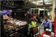  ?? PATRICK SEMANSKY — THE ASSOCIATED PRESS ?? In this photo, Baltimore Fire Department firefighte­r David Edwards, left, and Capt. Jason Turner chat alongside an elaborate “Christmas Gardens” model train display inside Engine House 45 in Baltimore. As one of the area’s oldest holiday customs,...