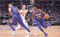  ?? TIM FULLER/USA TODAY SPORTS ?? Suns forward Josh Jackson (20) drives to the basket as center Alex Len sets a pick on Pistons guard Luke Kennard (5) during the second quarter on Wednesday in Detroit. The Suns lost 131-107.