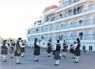  ?? ?? A local Pipe Band welcomes a cruise ship to Pictou.