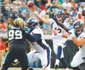  ??  ?? Broncos rookie quarterbac­k Paxton Lynch throws a pass during the first quarter Sunday against the Jacksonvil­le Jaguars. John Leyba, The Denver Post