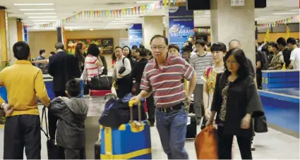  ?? SUNSTAR FILE ?? MORE FLIGHTS. Chinese tourists arrive at the Mactan-Cebu Internatio­nal Airport. The renewed economic ties between the Philippine­s and China have resulted in an increase in direct flights between Cebu and China.