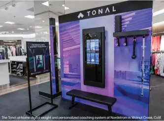  ??  ?? The Tonal at-home digital weight and personaliz­ed coaching system at Nordstrom in Walnut Creek, Calif.