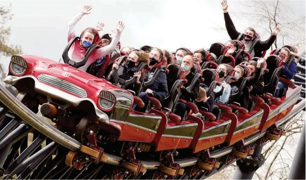  ?? Reuters ?? ↑
People react on the Stealth ride as Thorpe Park reopens in London on Monday.