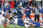  ?? [AP PHOTO] ?? New England Patriots wide receiver Julian Edelman is tackled by Buffalo Bills linebacker Matt Milano, right, and free safety Jordan Poyer during the first half on Monday night in Orchard Park, N.Y.