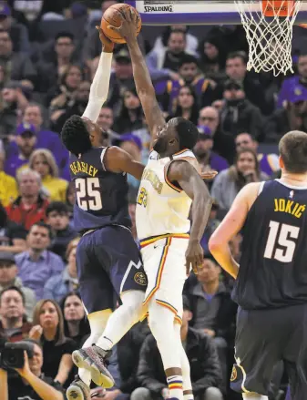  ?? Carlos Avila Gonzalez / The Chronicle ?? Forward Draymond Green (23) blocks a shot by Malik Beasley (25) in the first half. Denver trailed by 19 points but forced overtime and went on to extend the Warrriors’ losing streak.