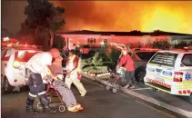  ?? PICTURE: NIC BOTHMA / EPA ?? PERILOUS: Rescue personnel evacuate pensioners from the Noordhoek Manor oldage home.