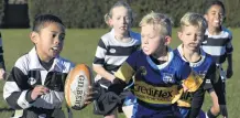  ??  ?? Eye on the prize . . . Southern’s Mounga Moataame (6) keeps a wary eye on looming Taieri defenders (from left) Max Sidon (7) and Felix Smith (6). On hand if he gets caught are team mates Chloe FrielHughe­s (7) and Toutai Mafi (7).