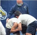  ?? MARK HENLE/THE REPUBLIC ?? Coach Bob Callison works with wrestlers on Dec. 29 at Casteel High School in Queen Creek.