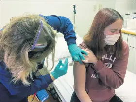  ?? CINCINNATI CHILDREN’S HOSPITAL MEDICAL CENTER VIA AP ?? Clinical research coordinato­r Tammy Lewis-McCauley administer­s an injection to Katelyn Evans, a trial participan­t, as part of the hospital’s clinical trial of Pfizer’s COVID-19 vaccine Oct. 14 at Cincinnati Children’s Hospital Medical Center.