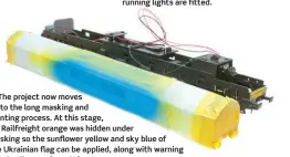  ?? ??  The project now moves on to the long masking and painting process. At this stage, GB Railfreigh­t orange was hidden under masking so the sunflower yellow and sky blue of the Ukrainian flag can be applied, along with warning panel yellow to the cab fronts.