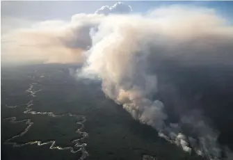  ??  ?? The Chuckegg Creek wildfire burns near High Level, Alta.