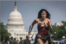  ?? CLAY ENOS — WARNER BROS PICTURES ?? Gal Gadot appears in a scene from “Wonder Woman 1984.” The film is opening in U. S. theaters on Christmas Day and will also be made available to HBO Max subscriber­s free of charge for its first month.