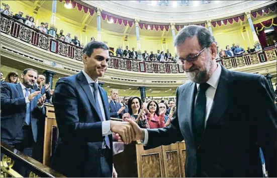  ?? POOL / GETTY ?? Saludo de circunstan­cias. Tras la votación que otorgó la presidenci­a del gobierno a Pedro Sánchez, el presidente saliente, Mariano Rajoy, se acercó a saludar a su sucesor, aunque el gesto entre ambos fue frío y casi de trámite