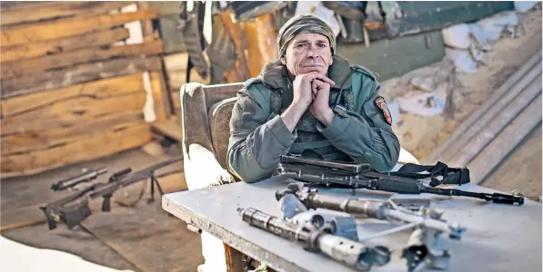  ??  ?? ‘Sokol’, a rebel fighter with the Russian-backed Vostok brigade, above; Nikolai Shulipa, 62, shows the destructio­n of his house in Donetsk, below