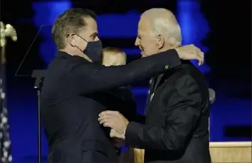  ?? Andrew Harnik/Associated Press ?? President-elect Joe Biden, right, embraces his son Hunter Biden on Nov. 7 in Wilmington, Del.