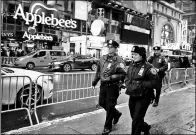  ?? EDUARDO MUNOZ / REUTERS ?? Police officers walk around Times Square ahead of New Year's Eve celebratio­ns in New York on Saturday.