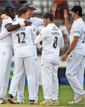  ?? ?? Hampshire’s players celebrate dismissing Somerset for 69 on Saturday