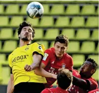  ?? -- Reuters ?? aerial battle: bayern Munich’s benjamin Pavard fights for the ball with borussia Dortmund’s Mats Hummels.