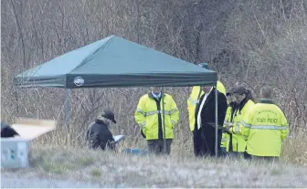  ?? TOM RETTIG / WORCESTER TELEGRAM & GAZETTE FILE ?? GRIM DISCOVERY: State police stand along Interstate 190 where police said a child’s body, later identified as Jeremiah Oliver, was found on April 18, 2014, in Sterling.