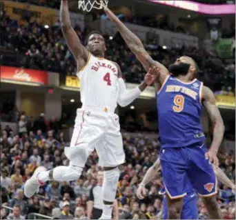  ?? MICHAEL CONROY — THE ASSOCIATED PRESS ?? Indiana Pacers guard Victor Oladipo (4) shoots in front of New York Knicks center Kyle O’Quinn (9) during the second half of an NBA basketball game in Indianapol­is, Sunday.