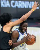  ?? JOHN KUNTZ/CLEVELAND.COM ?? Golden State Warriors forward Draymond Green drives to the basket guarded by Cleveland Cavaliers center Jarrett Allen on April 15 at Rocket Mortgage FieldHouse.