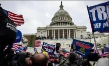  ?? Samuel Corum/Getty Images ?? Pro-Trump supporters storm the U.S. Capitol on Jan. 6, 2021. The House Jan. 6 committee’s final report asserts that Mr. Trump criminally engaged in a “multi-part conspiracy” to overturn the 2020 presidenti­al election.