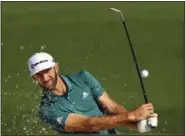  ?? ATLANTA JOURNAL-CONSTITUTI­ON VIA AP ?? Dustin Johnson hits from a bunker to the second green during a practice round at the Masters on Tuesday in Augusta, Ga.