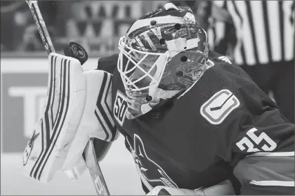  ?? The Canadian Press ?? Vancouver Canucks goalie Thatcher Demko makes a blocker save against the Colorado Avalanche in Vancouver on March 6.