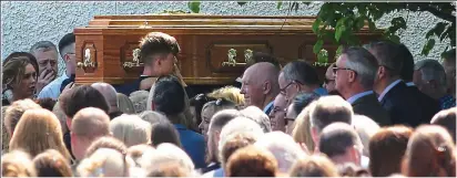  ??  ?? Grief: Coffin of Sandra O’Brien carried into St Finian’s Church by pallbearer­s including son Josh