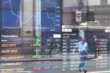  ??  ?? A pedestrian is reflected in a window of the Australian Securities Exchange (ASX) in Sydney on September 5. Australia’s buoyant economy posted strong growth in the second quarter of the year on the back of increasing exports, consumer and government spending, official data showed. — AFP photo