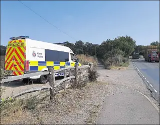 ??  ?? A police van parked on the A20 at the Bockham Lane junction near Mersham, close to where Mrs Ratcliffe’s body was found; right, the 76-year-old was seen on CCTV leaving the William Harvey Hospital