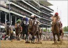  ?? JEFF ROBERSON — THE ASSOCIATED PRESS ?? Longshot Rich Strike, front right, with jockey Sonny Leon aboard, wins the 148th running of the Kentucky Derby on Saturday at Churchill Downs in Louisville, Ky.