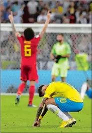  ?? ANDRE PENNER/ AP PHOTO ?? Brazil’s Neymar, front, reacts as Belgium’s Axel Witsel celebrates after Brazil is knocked out by Belgium following their quarterfin­al match at the 2018 soccer World Cup in the Kazan Arena in Russia on Friday.