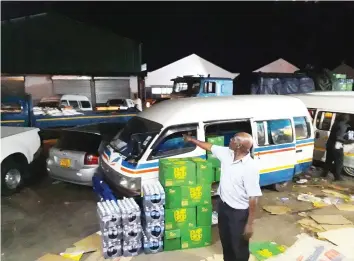  ??  ?? A Harare-based tuck shop takes delivery of its cooking oil in the evening. (Picture by Africa Moyo)