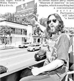  ??  ?? Leto rides the Sunset strip on top of a tour bus promoting Thirty Seconds to Mars’ new album, on Friday in Los Angeles, California. — AFP photo