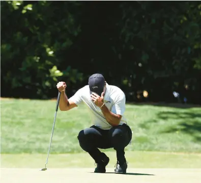  ?? MADDIE MEYER/GETTY ?? Tiger Woods lines up a putt on the fourth green during the third round of the Masters on Saturday at Augusta National Golf Club in Georgia.