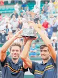  ?? EPA ?? Pierre-Hugues Herbert, right, and Nicolas Mahut celebrate with the trophy.